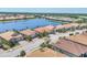 Aerial view of single Gathering homes in a lakeside community with beautiful landscaping and tile roofs at 7036 Highgate Ln, Lakewood Ranch, FL 34202