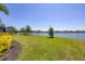 Beautiful backyard view of the green space and lake behind the property at 7036 Highgate Ln, Lakewood Ranch, FL 34202