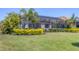 Expansive lawn, tropical landscaping, and screened in patio at 7036 Highgate Ln, Lakewood Ranch, FL 34202