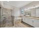 Bathroom featuring a walk-in shower, soaking tub, and a double sink vanity with granite countertop at 7036 Highgate Ln, Lakewood Ranch, FL 34202