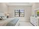 Bright bedroom with a large window providing an exterior view, and well-coordinated decor at 7036 Highgate Ln, Lakewood Ranch, FL 34202