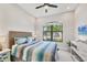 Comfortable bedroom with a ceiling fan and a large window with an exterior view at 7036 Highgate Ln, Lakewood Ranch, FL 34202