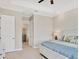 Tastefully designed bedroom with connecting door to bathroom, a ceiling fan, and neutral color palette at 7036 Highgate Ln, Lakewood Ranch, FL 34202