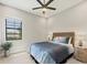 Comfortable bedroom with a woven headboard and a large window with an exterior view at 7036 Highgate Ln, Lakewood Ranch, FL 34202