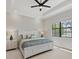 Well-lit bedroom featuring a ceiling fan, neutral colors, and a large window with an exterior view at 7036 Highgate Ln, Lakewood Ranch, FL 34202