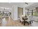 Dining room area with views to the living room, contemporary lighting, and large windows at 7036 Highgate Ln, Lakewood Ranch, FL 34202