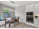 Bright dining area with contemporary lighting, a window seat, and built-in oven and microwave at 7036 Highgate Ln, Lakewood Ranch, FL 34202