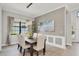 Dining room with natural light, contemporary lighting fixtures, and modern neutral furnishings at 7036 Highgate Ln, Lakewood Ranch, FL 34202