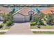 Beautiful single-Gathering home with well manicured landscaping and a three-car garage located on a body of water at 7036 Highgate Ln, Lakewood Ranch, FL 34202
