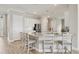 Beautiful kitchen island with granite countertops, white cabinets, barstool seating, and stainless steel appliances at 7036 Highgate Ln, Lakewood Ranch, FL 34202