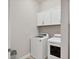 Bright laundry room featuring a modern washer and dryer and white cabinets for ample storage at 7036 Highgate Ln, Lakewood Ranch, FL 34202
