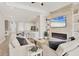 Bright living room with fireplace, white kitchen, and comfortable seating, perfect for entertaining at 7036 Highgate Ln, Lakewood Ranch, FL 34202