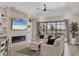 Cozy living room with stylish furniture, fireplace, and large windows overlooking the lake at 7036 Highgate Ln, Lakewood Ranch, FL 34202