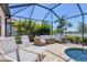 Screened-in patio with comfortable seating, loungers, lake view, and access to a sparkling swimming pool at 7036 Highgate Ln, Lakewood Ranch, FL 34202