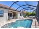 An inviting screened pool area includes a stone outdoor kitchen, in-pool seating and lounge furniture at 7036 Highgate Ln, Lakewood Ranch, FL 34202