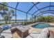 Beautiful lake view from screened in pool area with outdoor seating and gas firepit at 7036 Highgate Ln, Lakewood Ranch, FL 34202