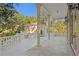 Large balcony overlooking the backyard with columns and railing at 1577 Alexander Rd, Belleair, FL 33756
