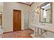 Bathroom featuring a single sink, a glass enclosed shower, detailed trim and stone flooring at 1577 Alexander Rd, Belleair, FL 33756