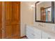 Bathroom featuring white cabinets, marble counter, sink, and lighting at 1577 Alexander Rd, Belleair, FL 33756