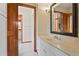 Bathroom with white cabinets, marble counters, sink, and vanity at 1577 Alexander Rd, Belleair, FL 33756