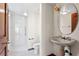 Bathroom featuring large sink, shower, and toilet at 1577 Alexander Rd, Belleair, FL 33756