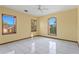 Bright bedroom with tile flooring, a ceiling fan, and large windows at 1577 Alexander Rd, Belleair, FL 33756