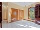Bright bedroom with a ceiling fan, tile flooring, two closets and a large window for lots of natural lighting at 1577 Alexander Rd, Belleair, FL 33756