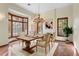 Bright dining room with a bay window, chandelier, and a fireplace at 1577 Alexander Rd, Belleair, FL 33756