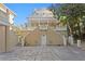 Beautiful three-story home with white brick, stone-tiled patio, and a grand facade at 1577 Alexander Rd, Belleair, FL 33756