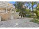 Spacious backyard featuring a stone patio and grand exterior architecture at 1577 Alexander Rd, Belleair, FL 33756