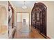 Elegant foyer showcasing grand wood doors, marble floors, and a view of the staircase at 1577 Alexander Rd, Belleair, FL 33756