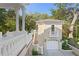 View of the guest house, garage, and exterior staircase at 1577 Alexander Rd, Belleair, FL 33756