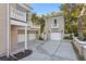 Exterior view of multiple garages attached to the home, showcasing their functional design at 1577 Alexander Rd, Belleair, FL 33756