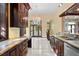 Spacious kitchen showcasing custom cabinets, granite countertops, and stainless steel appliances, with an expansive view at 1577 Alexander Rd, Belleair, FL 33756