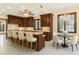 Spacious kitchen featuring custom wood cabinets, stone countertops, and a center island with seating at 1577 Alexander Rd, Belleair, FL 33756