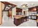 Open kitchen design with a center island, stainless steel appliances, and custom cabinetry with a carved wood design at 1577 Alexander Rd, Belleair, FL 33756