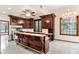 Gourmet kitchen featuring custom cabinetry, large island, and stainless steel appliances at 1577 Alexander Rd, Belleair, FL 33756