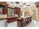 Gourmet kitchen featuring custom cabinetry, a central island, and modern appliances at 1577 Alexander Rd, Belleair, FL 33756