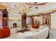 Lavish living room with a fireplace, detailed ceiling, and luxurious decor at 1577 Alexander Rd, Belleair, FL 33756