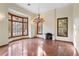 Elegant living room with a fireplace, large windows, and natural light at 1577 Alexander Rd, Belleair, FL 33756