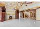 Elegant living room with detailed fireplace, ornate ceiling, and tiled floor at 1577 Alexander Rd, Belleair, FL 33756
