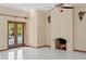 Living room featuring tile floors, a fireplace with brick trim, and French doors to balcony at 1577 Alexander Rd, Belleair, FL 33756