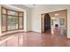 Bright living room with large window, wood trim and doorway at 1577 Alexander Rd, Belleair, FL 33756