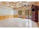 Expansive living room with detailed crown molding, double doors to a balcony, tiled floor, and ornate fireplace at 1577 Alexander Rd, Belleair, FL 33756