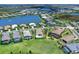 An aerial view of the homes and landscaping in a lakeside residential community on a clear sunny day at 17114 Verona Pl, Lakewood Ranch, FL 34202