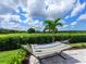 Inviting backyard featuring a hammock, lush lawn, and a view of the community green space at 17114 Verona Pl, Lakewood Ranch, FL 34202