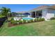 Well landscaped backyard showcasing pool, hammock, and patio, designed for outdoor enjoyment and relaxation at 17114 Verona Pl, Lakewood Ranch, FL 34202