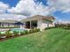 Expansive backyard with lush lawn and inviting pool area, perfect for outdoor activities and relaxation at 17114 Verona Pl, Lakewood Ranch, FL 34202