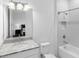 Bathroom showcasing white tile, a combined shower and tub, plus a vanity with marble countertop at 17114 Verona Pl, Lakewood Ranch, FL 34202
