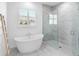 Relaxing bathroom featuring a freestanding tub, glass shower, and elegant tile work at 17114 Verona Pl, Lakewood Ranch, FL 34202
